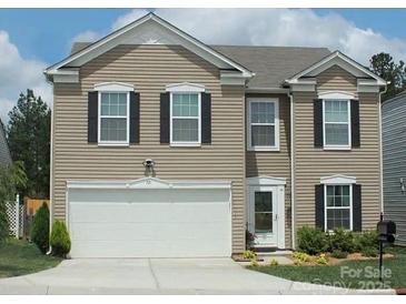 Charming two-story home featuring neutral siding, black shutters, and an attached two-car garage at 721 Nannyberry Ln, Concord, NC 28025