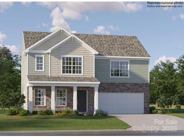 Charming two-story home with stone accents, attached two-car garage, and well-manicured lawn at 1102 Old Trade St, Edgemoor, SC 29712