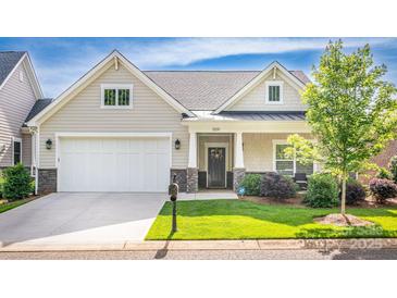Charming home featuring a well-manicured lawn, stone accents, and an inviting covered front porch and two car garage at 1109 Bunch Dr, Statesville, NC 28677
