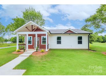 Charming single-story home with a covered front porch, well-manicured lawn and sidewalk to the front door at 1244 Bob Falls Rd, Shelby, NC 28150