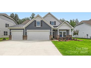 Charming two-story home with a three car garage, beautiful lawn, and manicured landscaping at 1528 Croydon St, Indian Land, SC 29707
