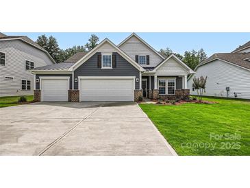 Charming home featuring a three-car garage, well-manicured lawn and inviting curb appeal at 1528 Croydon St, Indian Land, SC 29707