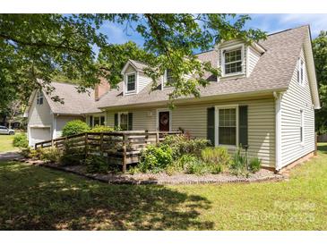 Charming home with a front yard featuring a wooden ramp and lush landscaping at 1818 Winfield Dr, Monroe, NC 28110