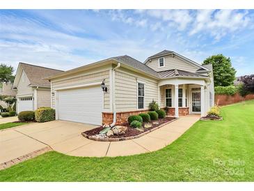 Charming single-story home featuring a well-manicured lawn, a two-car garage, and a welcoming front porch at 19106 Mallard Dr # 216, Fort Mill, SC 29707