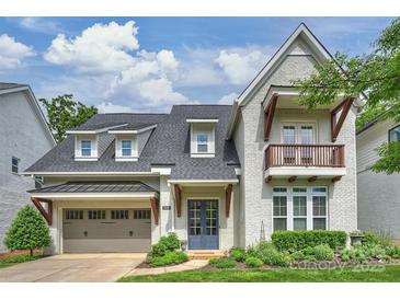 Charming home featuring neutral brick, balcony and inviting entrance with manicured landscaping at 2630 Mary Butler Way, Charlotte, NC 28226