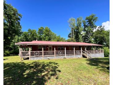 Charming single-story home with a red roof, inviting front porch, and lush green lawn at 3988 Old Hickory Rd, Lancaster, SC 29720