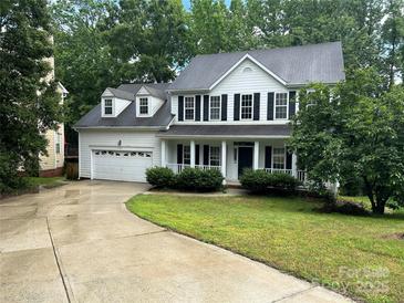 Charming two-story home boasts a two-car garage, dark shutters, and a welcoming front porch at 4504 Bellmore Ct, Charlotte, NC 28269
