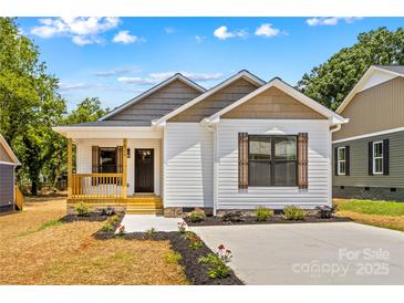Charming single-story home with a welcoming porch and well-manicured landscaping in a vibrant community at 626 W Bell St, Statesville, NC 28677