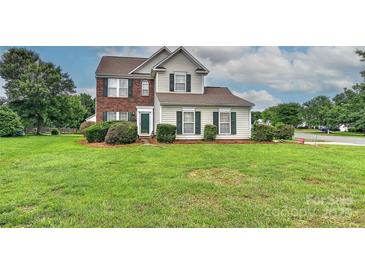Charming two-story home with a well-manicured lawn and mature landscaping at 7007 Broad Leaf Ct, Indian Trail, NC 28079