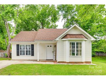 Charming single-Gathering home featuring a well-manicured lawn, a bay window, and inviting curb appeal at 7442 Crestside Ln, Charlotte, NC 28227