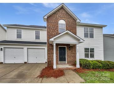 Charming two-story home featuring a brick facade, attached two-car garage, and inviting front porch at 752 Raindrops Rd, Gastonia, NC 28054
