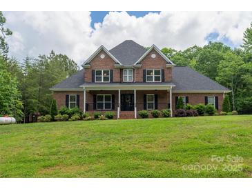 Charming two-story brick home featuring a covered porch and well-manicured lawn at 106 Hannaford Pl # 15, Gastonia, NC 28052