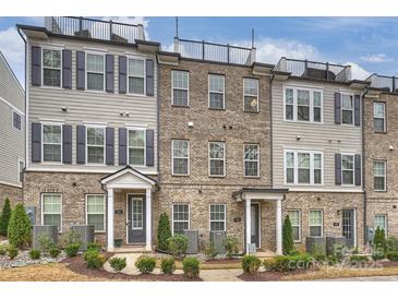 Beautiful brick townhomes with a rooftop patio and landscaping at 310 N Dotger N Ave # 4, Charlotte, NC 28204