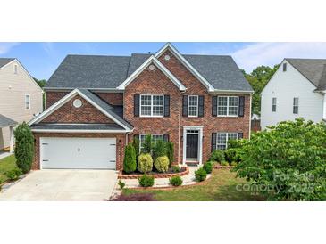 Charming two-story brick home with black shutters, landscaped yard, and an attached two-car garage at 4658 Cedar Rock Dr, Charlotte, NC 28273