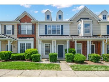 Charming townhome with a well-manicured lawn, inviting entryway, and classic architectural details at 13358 Calloway Glen Dr, Charlotte, NC 28273