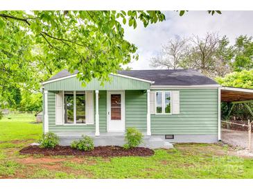 Charming home featuring a quaint front porch, complemented by manicured landscaping at 275 N Garrison Rd, Rock Hill, SC 29730
