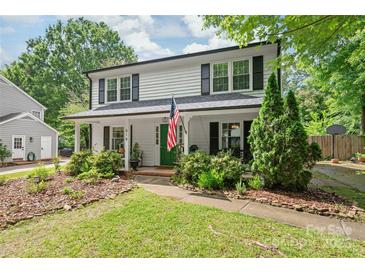Charming two-story home with a well-manicured lawn and a welcoming front porch at 618 Heathermoor Ct, Charlotte, NC 28209