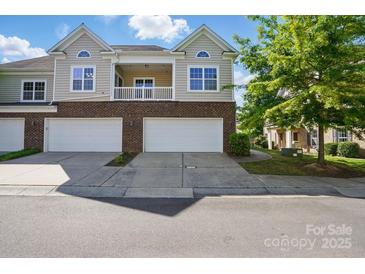 Charming townhome with two-car garage, balcony, and brick facade at 11209 Lazio Ln # 1, Charlotte, NC 28277