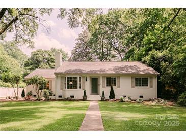 Charming one-story home with a lush green lawn and mature trees providing shade at 1184 Thornwell Ave, Rock Hill, SC 29732