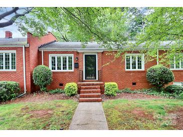 Charming brick home featuring a landscaped front yard and traditional architectural details at 1809 Jameston Dr, Charlotte, NC 28209