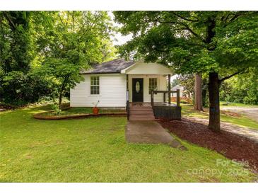 Charming single-story home featuring a cozy front porch and a well-maintained, tree-lined yard at 315 Rivers St, Rock Hill, SC 29730