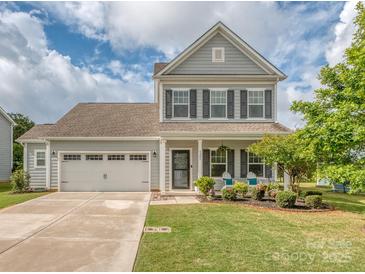 Charming two-story home featuring a well-manicured lawn, two-car garage, and inviting front porch at 4205 Bent Green Ln, Monroe, NC 28112