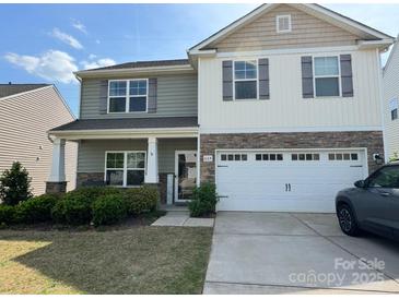 Charming two-story home with a two-car garage, stone accents, and well-maintained landscaping at 664 Cape Fear St, Fort Mill, SC 29715