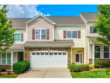 Inviting two-story townhouse featuring a stone facade and attached two-car garage at 809 River Park Rd, Belmont, NC 28012
