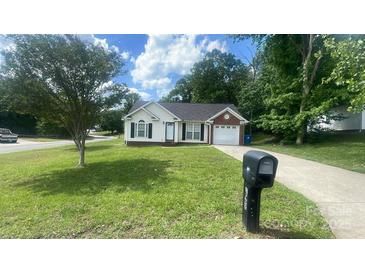 Charming single-story home with well-manicured lawn, garage, and inviting front entrance at 1062 Piney Church Rd, Concord, NC 28025