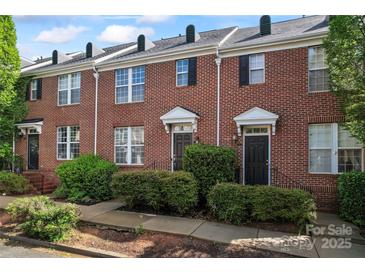Charming brick townhome with manicured landscaping, offering classic appeal and inviting curb appeal at 13838 Hill St, Huntersville, NC 28078