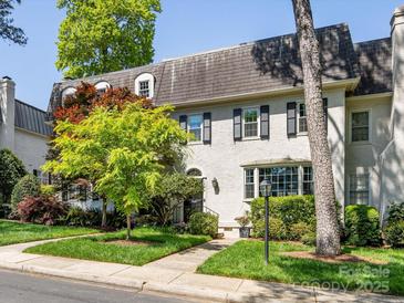 Charming home with stucco exterior, black shutters, and manicured landscaping at 161 Perrin Pl, Charlotte, NC 28207