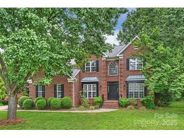 Traditional two-story brick home with manicured lawn and mature trees at 20812 Decora Dr, Cornelius, NC 28031