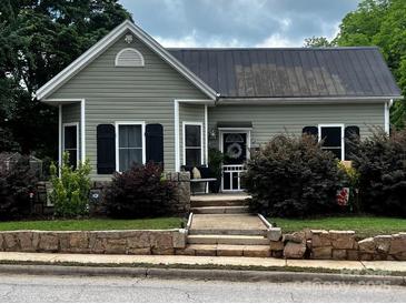 Charming home with new roof, stone accents, updated landscaping, and a cozy front porch at 303 N Main N St, Granite Quarry, NC 28146