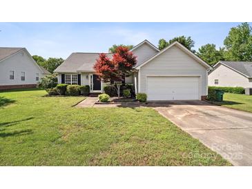 Charming single-story home with well-manicured lawn, lovely landscaping and an attached two-car garage at 8105 Castlemaine Dr, Matthews, NC 28104