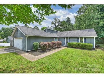 Charming single-story home features a well-maintained lawn and attached one car garage at 11619 Rimrock Canyon Dr, Charlotte, NC 28226