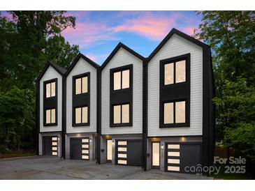 Modern townhomes with a sleek black and white color scheme and eye-catching garage doors at 158 Mattoon St, Charlotte, NC 28216
