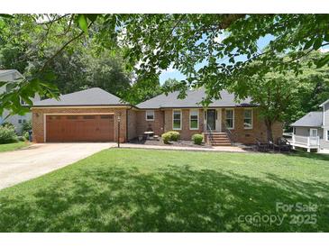 Charming brick home with a well-manicured lawn and a two-car garage, perfect for curb appeal at 16433 Grapperhall Dr, Huntersville, NC 28078