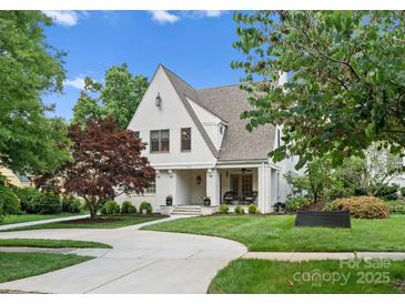 Charming white brick home with a manicured lawn and a curved driveway at 236 Wales Ave, Charlotte, NC 28209