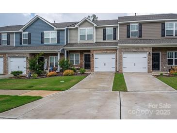Charming townhomes featuring mixed material exteriors and attached one car garages at 348 Zocalo Dr, Gastonia, NC 28056