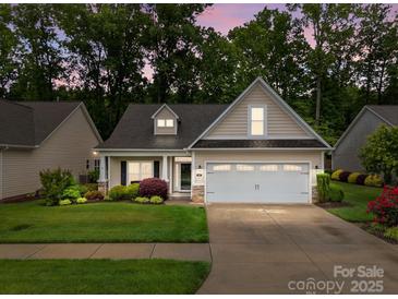 Charming single-Gathering home featuring a two-car garage, manicured lawn, and mature trees at 422 Drake Ln, Salisbury, NC 28146
