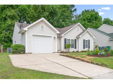 Charming single-story home with an attached garage, well-maintained lawn, and mature trees at 4719 Sahalee Ln, Charlotte, NC 28216