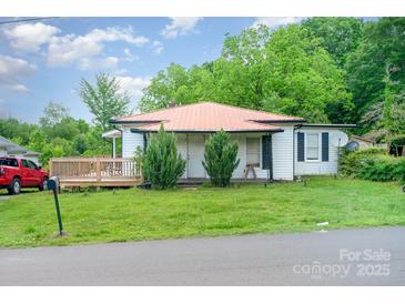 Charming single-story home with a metal roof and a inviting wooden deck at 511 W Finger St, Maiden, NC 28650