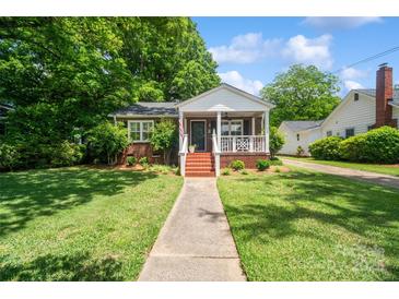 Charming brick home featuring a covered front porch and well-maintained landscaping, perfect curb appeal at 512 Forest Ln, Rock Hill, SC 29730