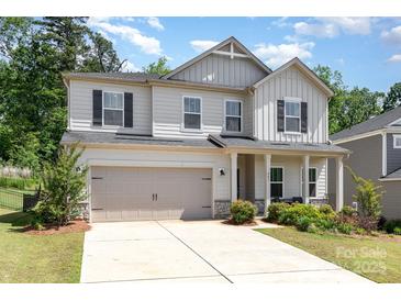 Charming two-story home with a two-car garage, manicured lawn, and inviting front porch with supporting columns at 941 Rachel Anne Dr, Belmont, NC 28012