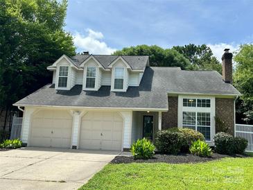 Charming home featuring a two-car garage and landscaped front yard at 14211 Harlequin Dr, Charlotte, NC 28273