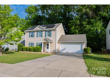 Charming two-story home with a two car garage, solar panels, and a well-manicured front lawn at 1518 Glenbar Ct, Clover, SC 29710