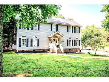 Charming two-story home with grey siding, black shutters, and a well-manicured lawn at 1575 Lewis Farm Rd, Kings Mountain, NC 28086
