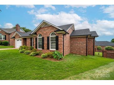 Charming brick home featuring a landscaped yard and classic black shutters at 1909 Wexford Ct, Gastonia, NC 28054