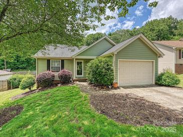 Charming one-story home with green siding, manicured lawn, and an attached one-car garage at 2927 Dubberly Ct, Matthews, NC 28105