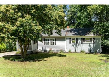 Charming single-story home featuring a well-maintained lawn, light gray siding, and a tree providing shade at 3331 Eastwood Dr, Charlotte, NC 28205